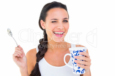 Pretty brunette having cup of tea