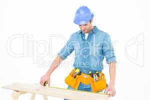 Carpenter measuring wooden plank