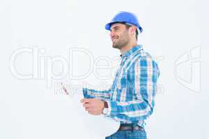 Smiling engineer looking away while holding blueprint