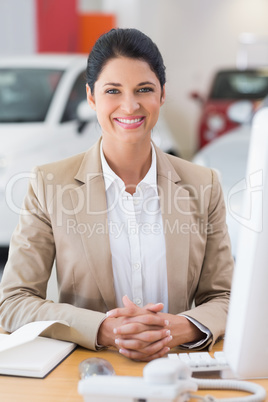 Happy businesswoman working at her desk