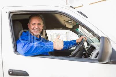 Delivery driver showing thumbs up driving his van
