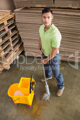 Man moping warehouse floor