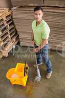 Man moping warehouse floor