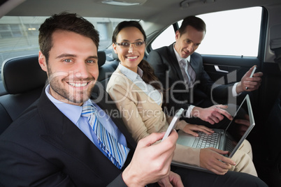 Business team working in the back seat