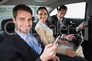 Business team working in the back seat