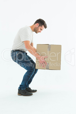 Courier man picking up cardboard box