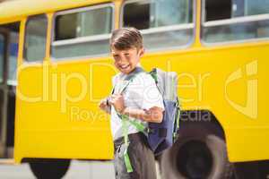 Cute pupil walking to the school bus