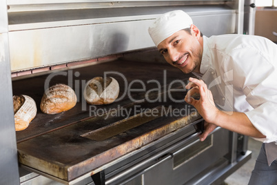 Happy baker by open oven