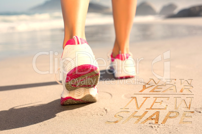 Composite image of fit woman walking on the beach