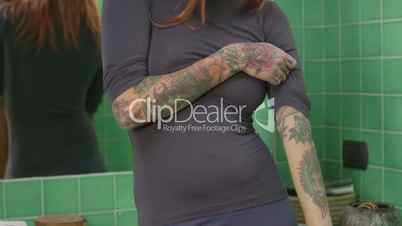 Confident Girl Woman With Tattoos Smiling At Camera In Bathroom