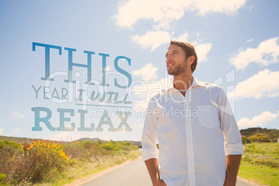 Composite image of handsome casual man standing on a road