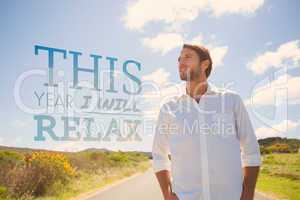 Composite image of handsome casual man standing on a road