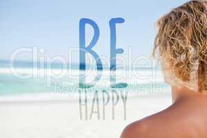 Composite image of young blonde man looking at the sea while sun