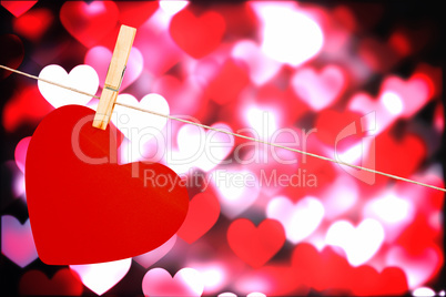 Composite image of heart hanging on line Composite image of heart hanging on line