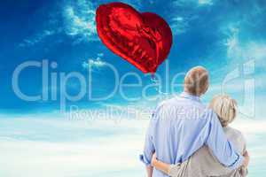 Composite image of mature couple hugging and looking