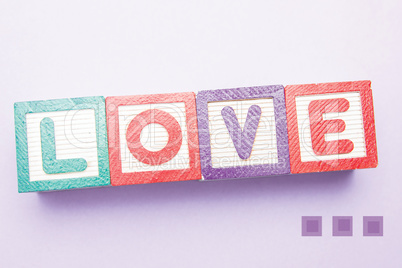 Composite image of building blocks spelling out love