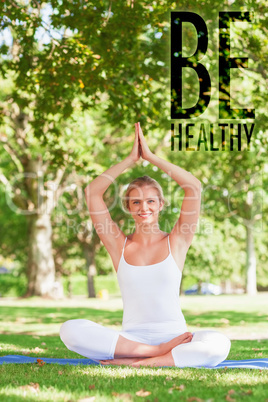 Composite image of cute young woman doing yoga sitting on an exe