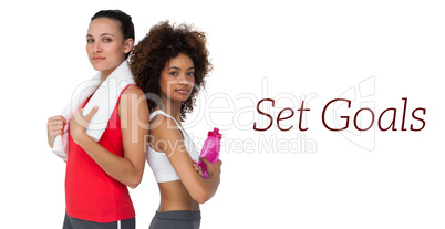 Fit women standing with waterbottle and towel