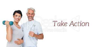 Happy fit couple with dumbbell and water bottle