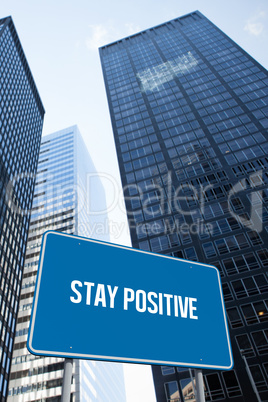 Stay positive against low angle view of skyscrapers