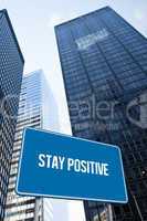 Stay positive against low angle view of skyscrapers