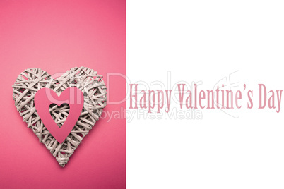 Composite image of wicker heart ornament with pink paper cut out