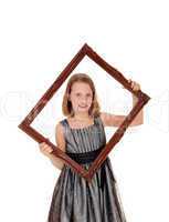 Pretty girl holding picture frame.