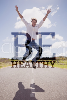 Composite image of handsome casual man leaping on a road smiling Composite image of handsome casual man leaping on a road smiling