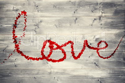 Composite image of love spelled out in petals Composite image of love spelled out in petals