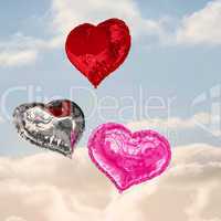 Composite image of love heart balloons