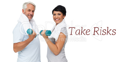 Fit mature couple exercising with dumbbells