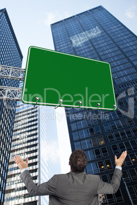 Composite image of businessman posing with arms raised