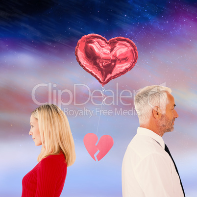 Composite image of couple not talking with broken heart between