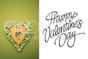 Composite image of wicker heart ornament with green paper cut ou