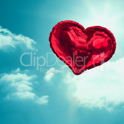 Composite image of red heart balloon