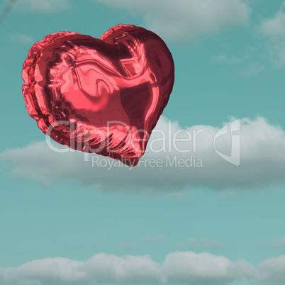 Composite image of red heart balloon