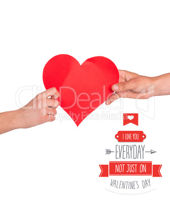 Composite image of hands holding red heart