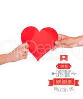 Composite image of hands holding red heart