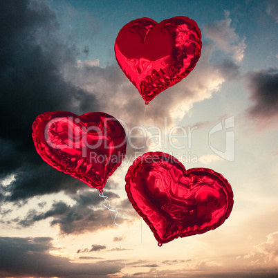 Composite image of love heart balloons