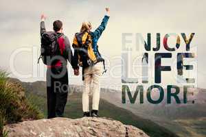 Composite image of excited couple reaching the top of their hike