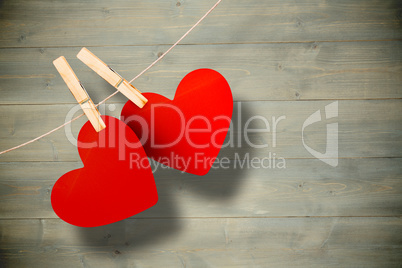 Composite image of hearts hanging on line