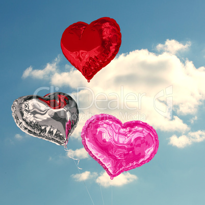 Composite image of love heart balloons