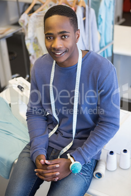 Smiling university student sitting with meter