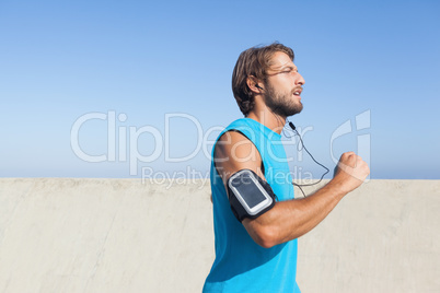 Fit man jogging on promenade