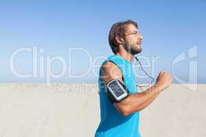 Fit man jogging on promenade