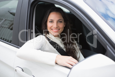 Pretty woman smiling and driving