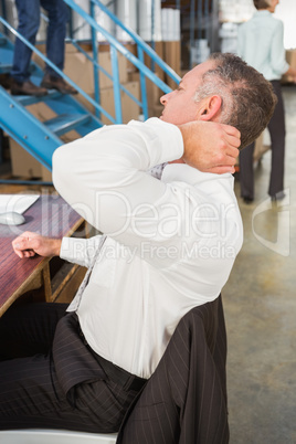 Side view of warehouse manager using computer