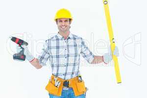 Technician holding portable drill and spirit level