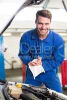 Mechanic examining under hood of car