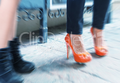 Blurred picture of women making shopping, legs detail